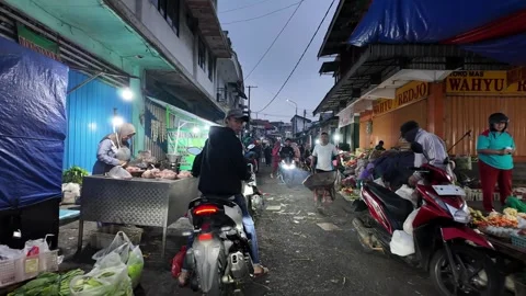 Dim light spills over wet market alley Stock Footage 345200394