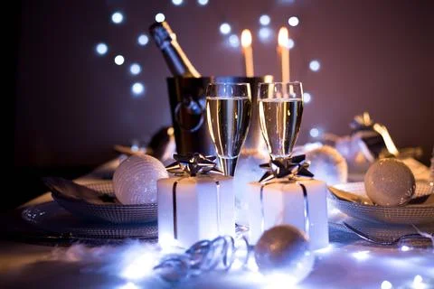 Dim light white silver and blue romantic new year eve or christmas table in a Stock Photos