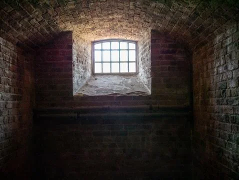 Dim Old Brick Cellar Interior with Window Stock Photos