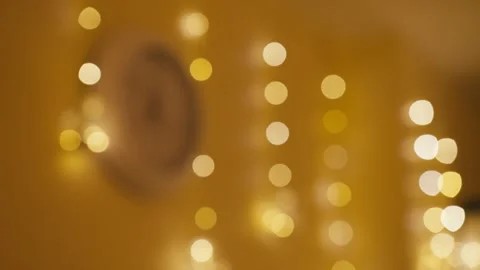 Dim string lights and clock establish intimate holiday atmosphere 스톡 동영상 323102263