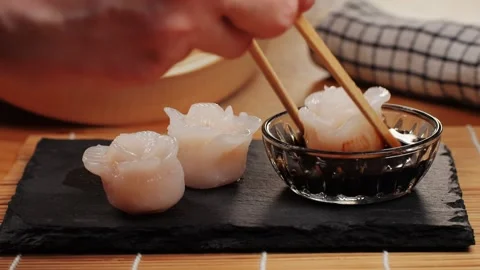 Dim sum on black plate close-up macro. Pouring food in sauce. Chinese dessert Stock Footage 266959544