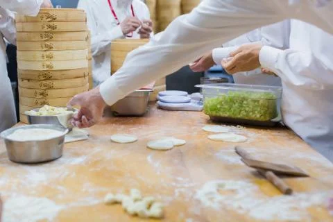 Dim Sum chefs working wrapping dumplings at famous restaurant in Taiwan. Stock Photos