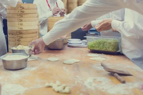 Dim Sum chefs working wrapping dumplings at famous restaurant in Taiwan. Stock Photos