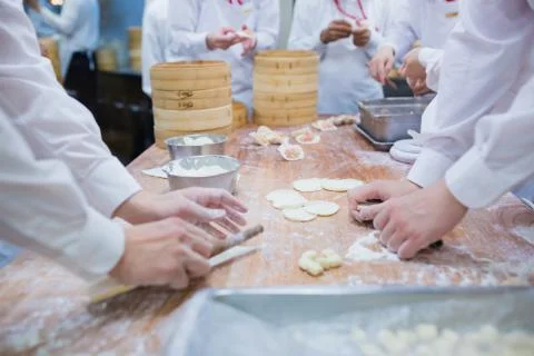 Dim Sum chefs working wrapping dumplings at famous restaurant in Taiwan. Stock Photos