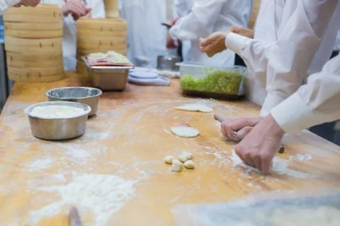 Dim Sum chefs working wrapping dumplings at famous restaurant in Taiwan. Stock Photos