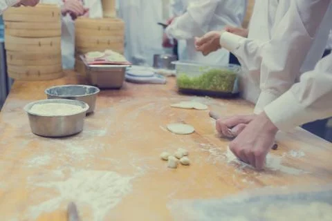 Dim Sum chefs working wrapping dumplings at famous restaurant in Taiwan. Stock Photos