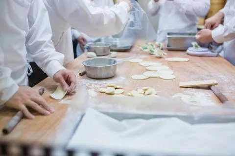 Dim Sum chefs working wrapping dumplings at famous restaurant in Taiwan. Stock Photos