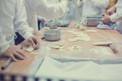 Dim Sum chefs working wrapping dumplings at famous restaurant in Taiwan. Stock Photos