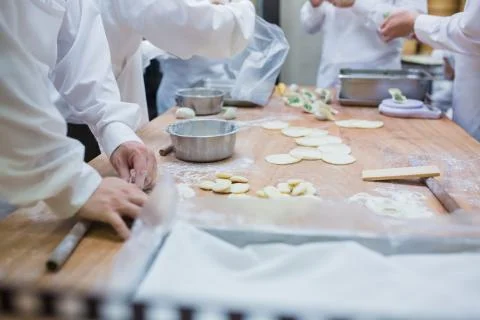 Dim Sum chefs working wrapping dumplings at famous restaurant in Taiwan. Stock Photos