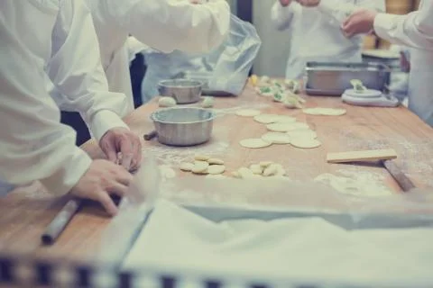 Dim Sum chefs working wrapping dumplings at famous restaurant in Taiwan. Stock Photos