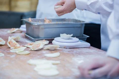 Dim Sum chefs working wrapping dumplings at famous restaurant in Taiwan. Stock Photos