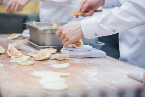 Dim Sum chefs working wrapping dumplings at famous restaurant in Taiwan. Stock Photos