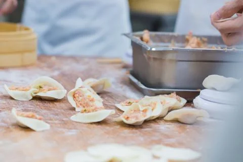 Dim Sum chefs working wrapping dumplings at famous restaurant in Taiwan. Stock Photos
