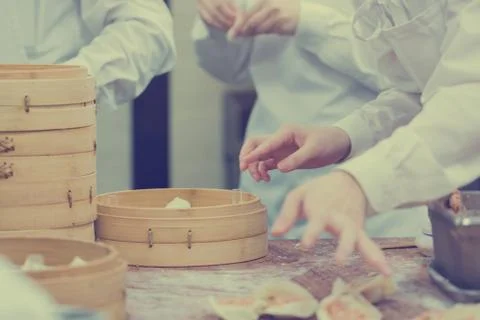 Dim Sum chefs working wrapping dumplings at famous restaurant in Taiwan. Stockfoto's