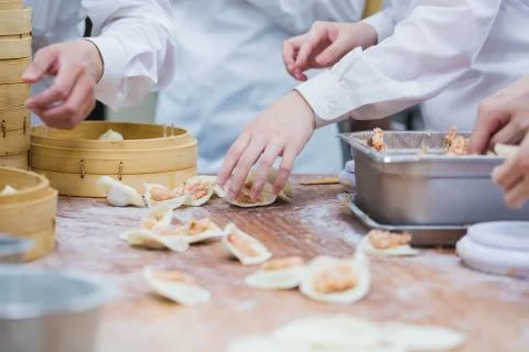 Dim Sum chefs working wrapping dumplings at famous restaurant in Taiwan. Stock Photos