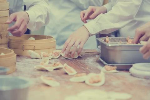 Dim Sum chefs working wrapping dumplings at famous restaurant in Taiwan. Stock Photos
