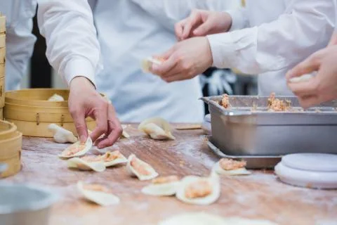 Dim Sum chefs working wrapping dumplings at famous restaurant in Taiwan. 写真素材