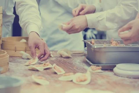 Dim Sum chefs working wrapping dumplings at famous restaurant in Taiwan. Stock Photos