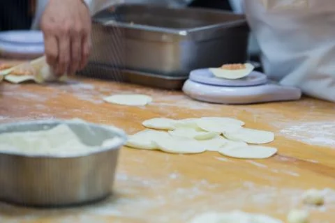 Dim Sum chefs working wrapping dumplings at famous restaurant in Taiwan. Stock Photos