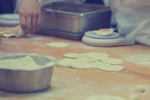 Dim Sum chefs working wrapping dumplings at famous restaurant in Taiwan. Stock Photos