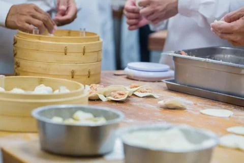 Dim Sum chefs working wrapping dumplings at famous restaurant in Taiwan. Stock Photos