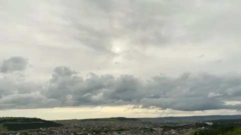 Dim Sun Breaks Through Dark Storm Clouds Over Rural Town Stock Footage 336362136