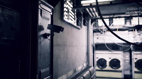 Dim urban laundry area. Gritty maintenance space with surveillance cameras Video stock 335594699