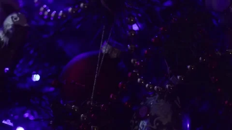 Dimly Lit Christmas Tree With Beaded Garlands and Colorful Ornaments in Night Stock Footage 329558048