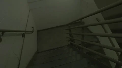 Dimly Lit Concrete Staircase in Dark Stairwell Stock Footage 343948035