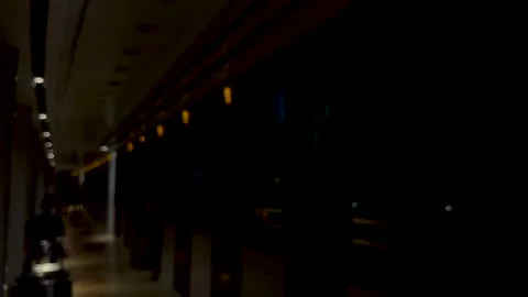 Dimly lit corridor with reflections and warm lighting creating a mysterious.. Stock Footage 340221351