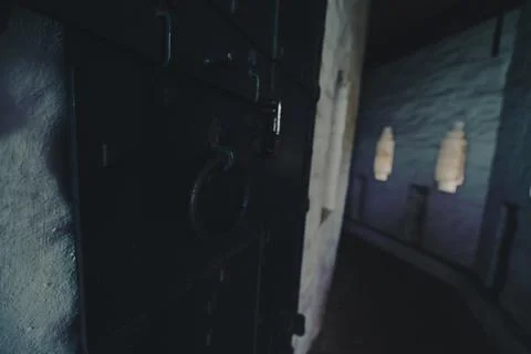 Dimly lit corridor with small windows in an ancient building Stock Photos
