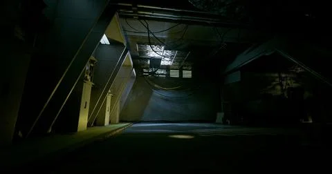 Dimly lit industrial space with shadows and cables in the background Stock Illustration