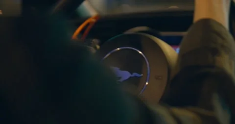 In the dimly lit night, a captivating close-up captures the hands skillfully Stock Footage 242053576