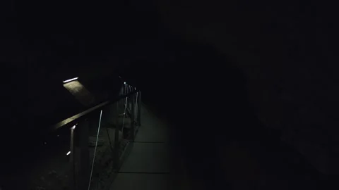 Dimly lit pathway through depths of Oziđana pećina cave, Krka National Park. Stock Footage 259075768