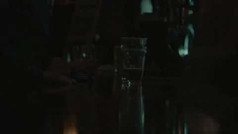 Dimly Lit Pub Bar Counter with a Glass of Beer Stock Footage 343954145
