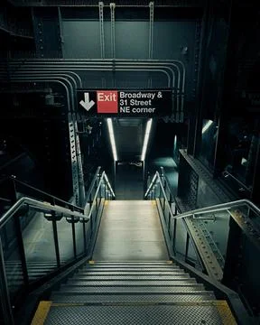 A dimly lit staircase leads to an exit at Broadway &amp; 31 Street NE corner in.. Stock Photos
