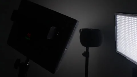 Dimly Lit Studio with LED Panel and Microphone Setup Stockbeeldmateriaal 334580796