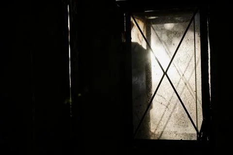 Dimly Lit Window with Crisscross Pattern Stock Photos