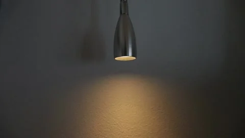 A dimmable light in a dark room and its effect on a wall. The brightness of the 動画素材 131706742