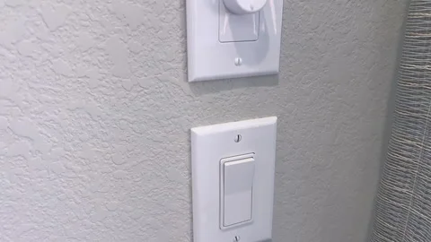 Dimmer light switch on textured wall close-up Stock Footage 344940762
