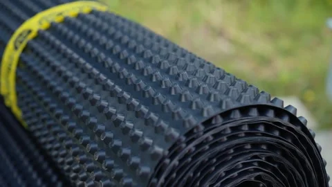 Dimpled drainage membrane roll for foundation waterproofing Stock Footage 341294414