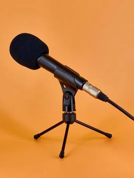 Dinamic microphone on a tripod table stand with protective sponge. Stock Photos