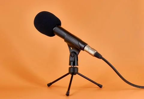 Dinamic microphone on a tripod table stand with protective sponge. Stock Photos