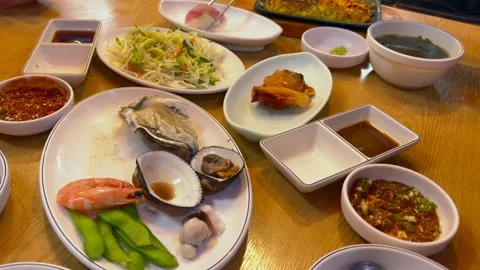 Diner dips fresh sushi into soy sauce with wasabi, enhancing umami flavors Stock Footage 301992487