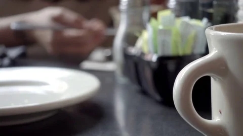 Diner scene - spreading jam on toast coffee mug handle plate 4K 스톡 동영상 80968784