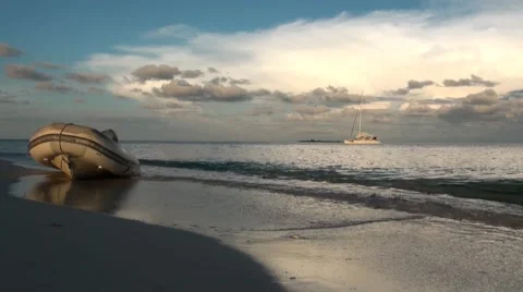 A dinghy lies on a beautiful sandy beach Stock Footage 44400014
