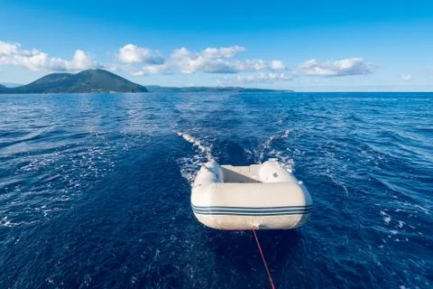 Dinghy (or dingey) inflatable small boat towed by a yacht in the Mediterranea Stock Photos