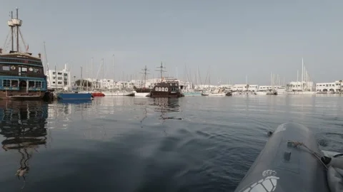 A dinghy pulling out of the Monastir marina in Tunisia Stock-Footage 243037413