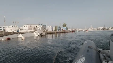 A dinghy pulling out of the Monastir marina in Tunisia Stock Footage 243116076
