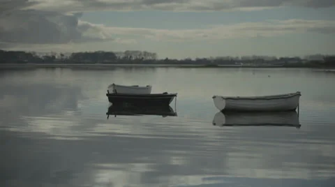 Dinghy sitting in flat calm harbour 스톡 동영상 34291094